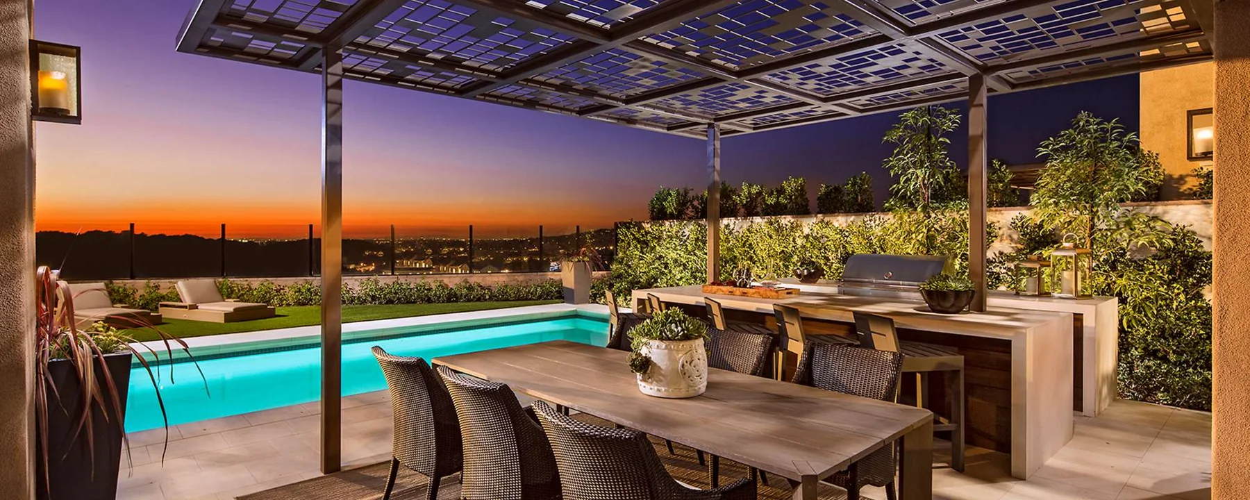 Pool terrace and home illuminated at dusk